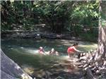 Kids playing in the river at BANDERA PIONEER RV RIVER RESORT - thumbnail