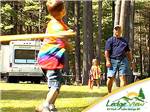 Father playing baseball with children at LEDGEVIEW RV PARK - thumbnail