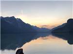 A placid lake with mountains on horizon at HAINES HITCH-UP RV PARK - thumbnail