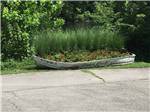 A boat used as a flower planter at COOPER CREEK RESORT & CAMPGROUND - thumbnail
