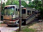 A motorhome in a gravel RV site at COOPER CREEK RESORT & CAMPGROUND - thumbnail