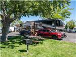 A fifth wheel trailer parked next to the green grass at SHAMROCK RV PARK - thumbnail