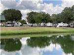 RVs parked with a lake view at SCHULENBURG RV PARK - thumbnail