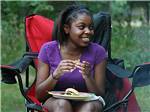 Girl eating lunch at LEBANON HILLS CAMPGROUND - thumbnail