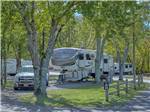 A fifth wheel trailer in a pull thru site at CLABOUGH'S CAMPGROUND - thumbnail