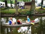 A family in a metal canoe at CAMP LORD WILLING RV PARK & CAMPGROUND - thumbnail