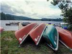 A stack of canoes by the water at TWIN TAMARACK FAMILY CAMPING & RV RESORT - thumbnail