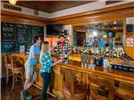 People talking and drinking at the bar at PALM CANYON HOTEL AND RV RESORT - thumbnail