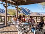 People sitting at tables on the patio at PALM CANYON HOTEL AND RV RESORT - thumbnail