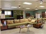 A lounge-area with l-shaped sofa set and 60s-style coffee table at ELK CREEK RV PARK - thumbnail