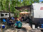 People sitting outside of an RV at INDIAN ROCK RV PARK - thumbnail