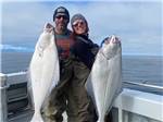 A couple of anglers displaying their catches of the day at ALASKAN ANGLER RV RESORT & CABINS - thumbnail