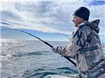 Young man fishing during a beautiful day at ALASKAN ANGLER RV RESORT & CABINS - thumbnail