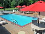 Swimming pool surrounded by outdoor seating at MEMPHIS GRACELAND RV PARK & CAMPGROUND - thumbnail