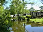 RVs parked in sites by the water at LAKE AIRE RV PARK & CAMPGROUND - thumbnail