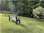 A park bench overlooking the lake at LAKE AIRE RV PARK & CAMPGROUND - thumbnail