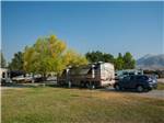 Large brown RV with blue Honda CRV parked behind it at MOUNTAIN VIEW RV PARK - thumbnail