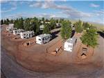 A row of gravel sites with benches at METEOR CRATER RV PARK - thumbnail
