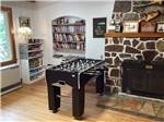 The foosball table by the fireplace at RIVERFRONT RV PARK - thumbnail