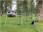 A swing set and slide  at RIVERFRONT RV PARK - thumbnail