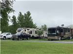 A couple of RVs in grassy sites at RIVERFRONT RV PARK - thumbnail