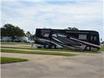 A motorhome in a paved pull thru site at TRADERS VILLAGE RV PARK - thumbnail