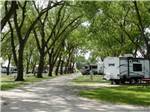 The tree lined road with RV sites at ON-UR-WA RV PARK - thumbnail