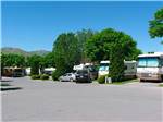 Paved road with RVs in sites at COWBOY RV PARK - thumbnail