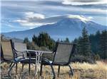 A table and chairs looking at a mountain at TRAILER LANE CAMPGROUND - thumbnail