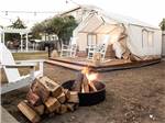 A glamping canvas cabin with a fire in front at MARINA DUNES RV RESORT - thumbnail