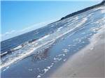 Waves lapping on the beach at OCEAN SURF RV PARK - thumbnail