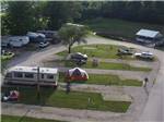 Aerial view of RVs, Trailers, tents and vehicles in grassy and dirt spots at CAHOKIA RV PARQUE - thumbnail
