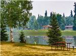 A picnic table overlooking the water at RIVER'S EDGE RV PARK & CAMPGROUND - thumbnail