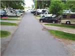 The paved road in between gravel RV sites at FOSSIL VALLEY RV PARK - thumbnail