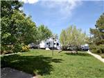 White RVs parked near outdoor light and green grass at KEYSTONE RV PARK - thumbnail