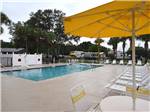 Lounge chairs by the swimming pool at OCALA SUN RV RESORT - thumbnail