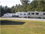 A grassy area in front of some RV sites at FERN LAKE CAMPGROUND & RV PARK - thumbnail