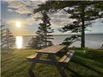 A picnic bench near the water at CAMPING COLIBRI BY THE SEA - thumbnail