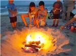 Kids roasting marshmallows on the beach at CAMP HATTERAS RV RESORT & CAMPGROUND - thumbnail