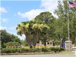 The entrance with three palm trees at FORT CLARK SPRINGS RV PARK - thumbnail