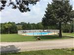 The fenced in swimming pool at RUSTIC TRAILS RV PARK - thumbnail