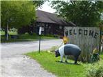 Painted pig statue in front of sign at INTERSTATE RV PARK - thumbnail