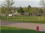 Red fire hydrant with RVs and green spaces in background at ROBIDOUX RV PARK - thumbnail