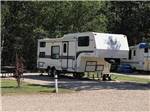 A fifth wheel trailer in a back in RV space at SHERK'S RV PARK - thumbnail