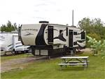 A fifth wheel trailer in a gravel site at NORTHERN LIGHTS RV PARK - thumbnail