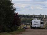 Cougar trailer in spacious RV site with picnic bench at NORTHERN LIGHTS RV PARK - thumbnail