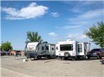 A pair of trailers in adjoining campsites at TOWN & COUNTRY RV PARK - thumbnail
