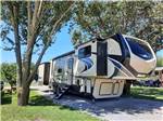 A fifth wheel trailer in a gravel site at DAD'S BLUEGRASS CAMPGROUND - thumbnail