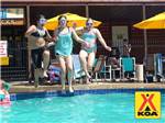 A group of kids jumping into the pool at MILTON KOA - thumbnail