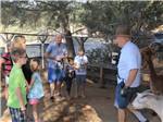 An employee talking to a group of people in the petting farm at YOSEMITE PINES RV RESORT AND FAMILY LODGING - thumbnail